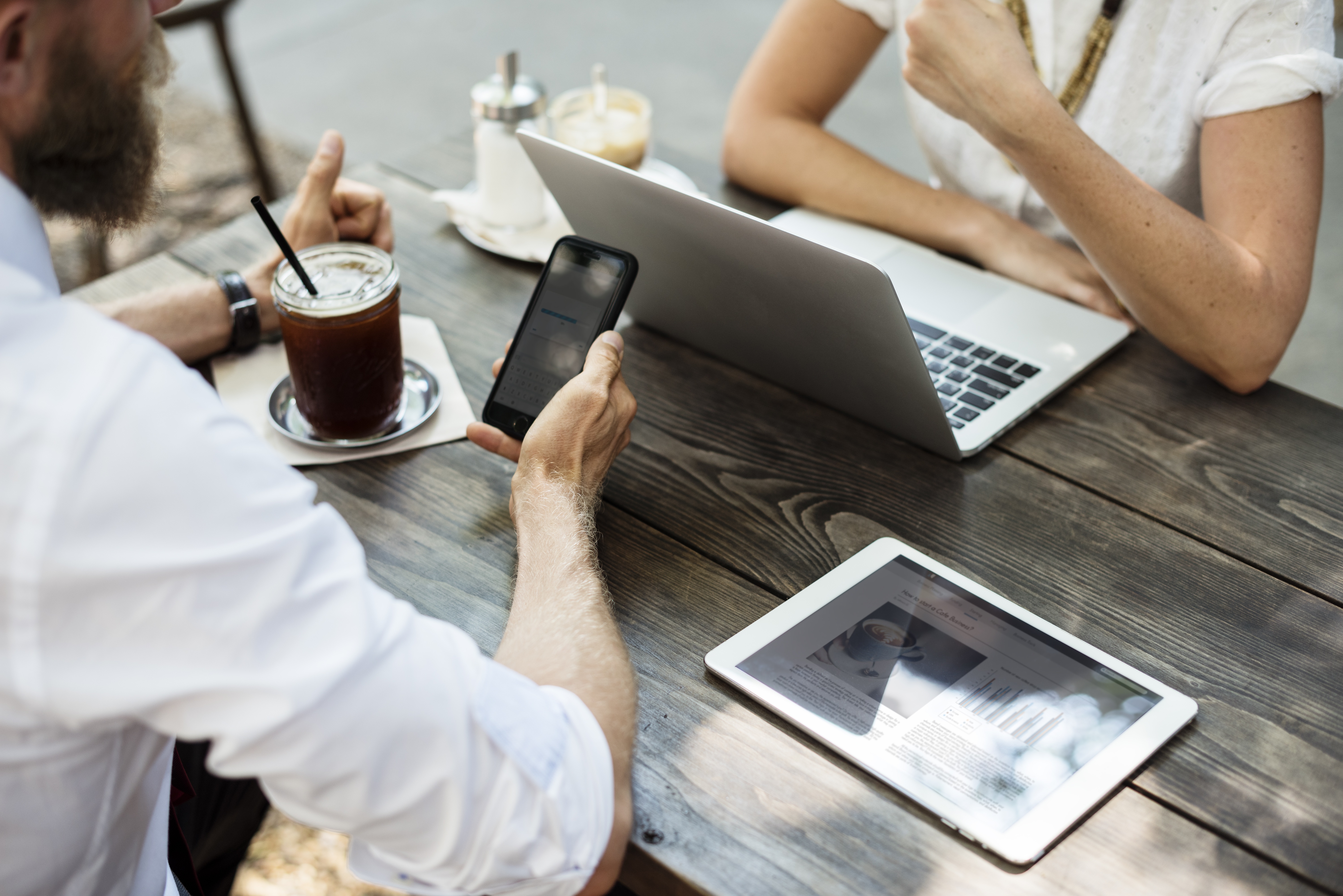 people meeting with smartphone, laptop, and tablet