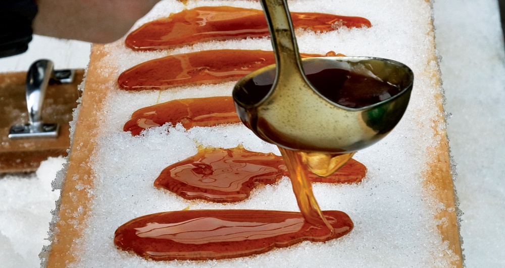Hot Maple Syrup being poured onto snow to make candy