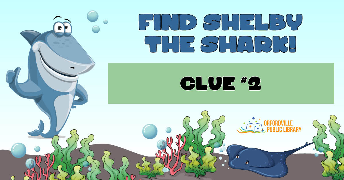Illustrated underwater scene featuring a shark, colorful seaweed, and a stingray. Words read: Find Shelby the Shark. Clue #2.