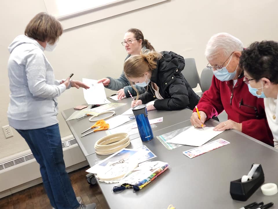 Evansville locals work on their individual squares for a community quilt.