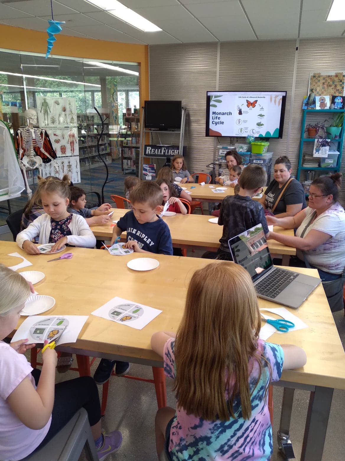 Members of MPL's Monarch Club work on a butterfly lifecycle craft in The Spark.