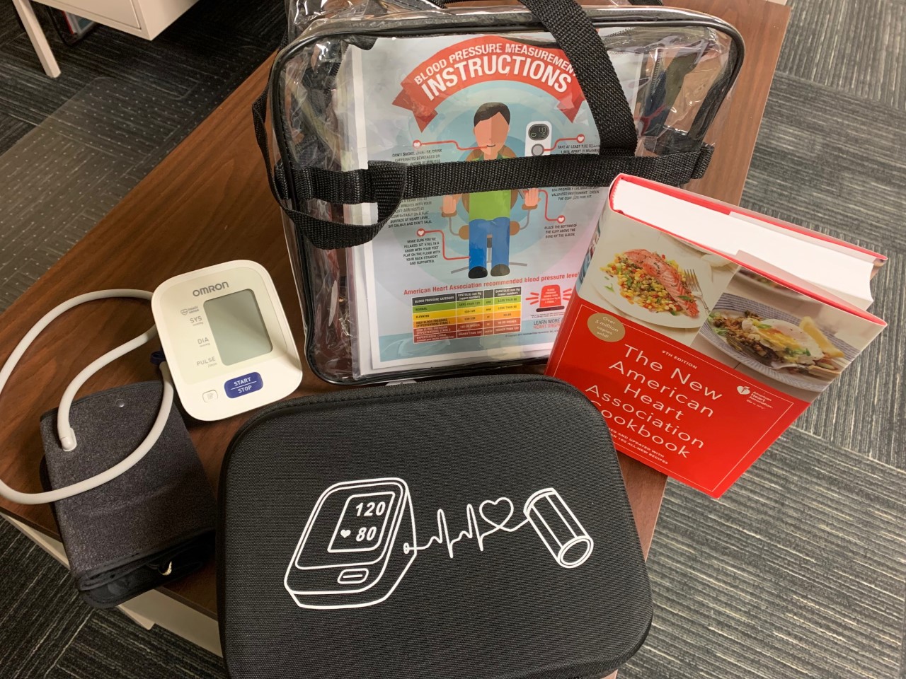 Heart Health Kit: Bag, Cookbook, Blood Pressure Monitor & Cuff, and informational cards.