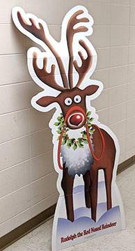 Cardboard standup of illustrated Rudolph the Red Nosed Reindeer